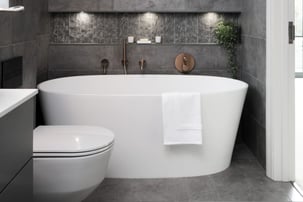 63e8544cf115fa1b2e082d8f_white-freestanding-bath-in-cave-inspired-bathroom
