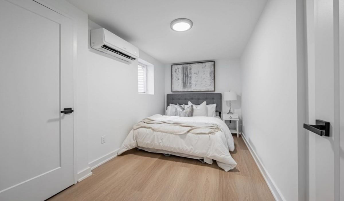 A cozy bedroom of a legal basement apartment