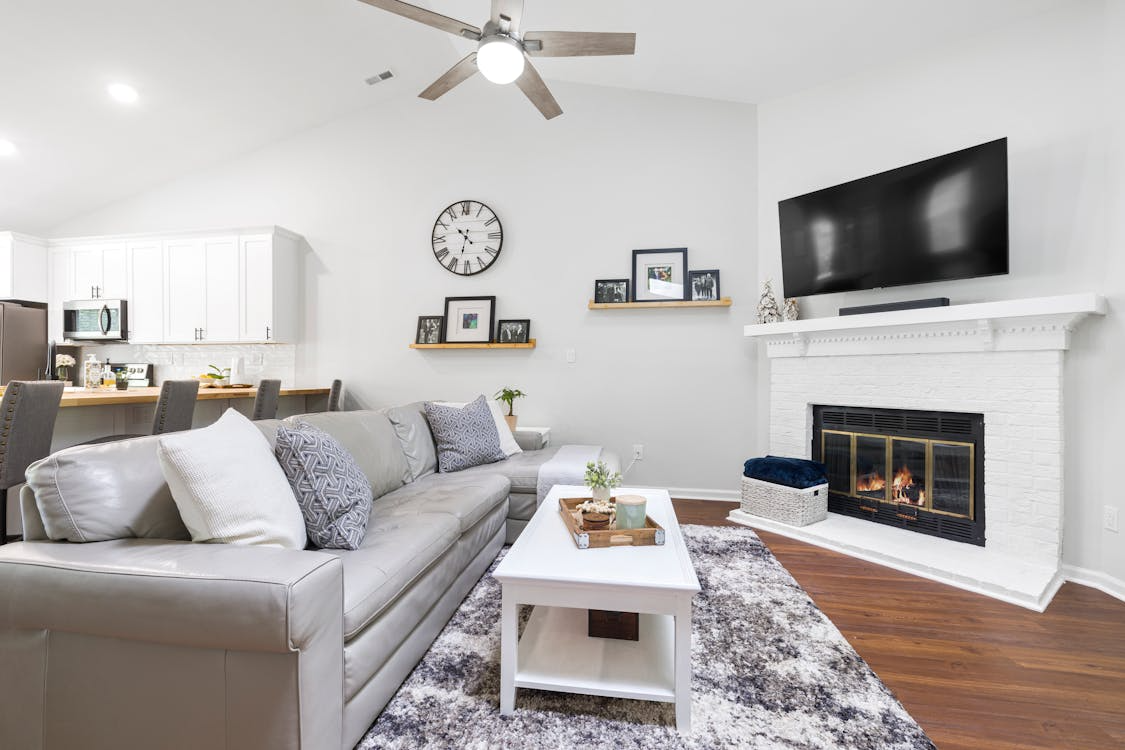 Bright basement renovation of family room with fireplace and modern decor
