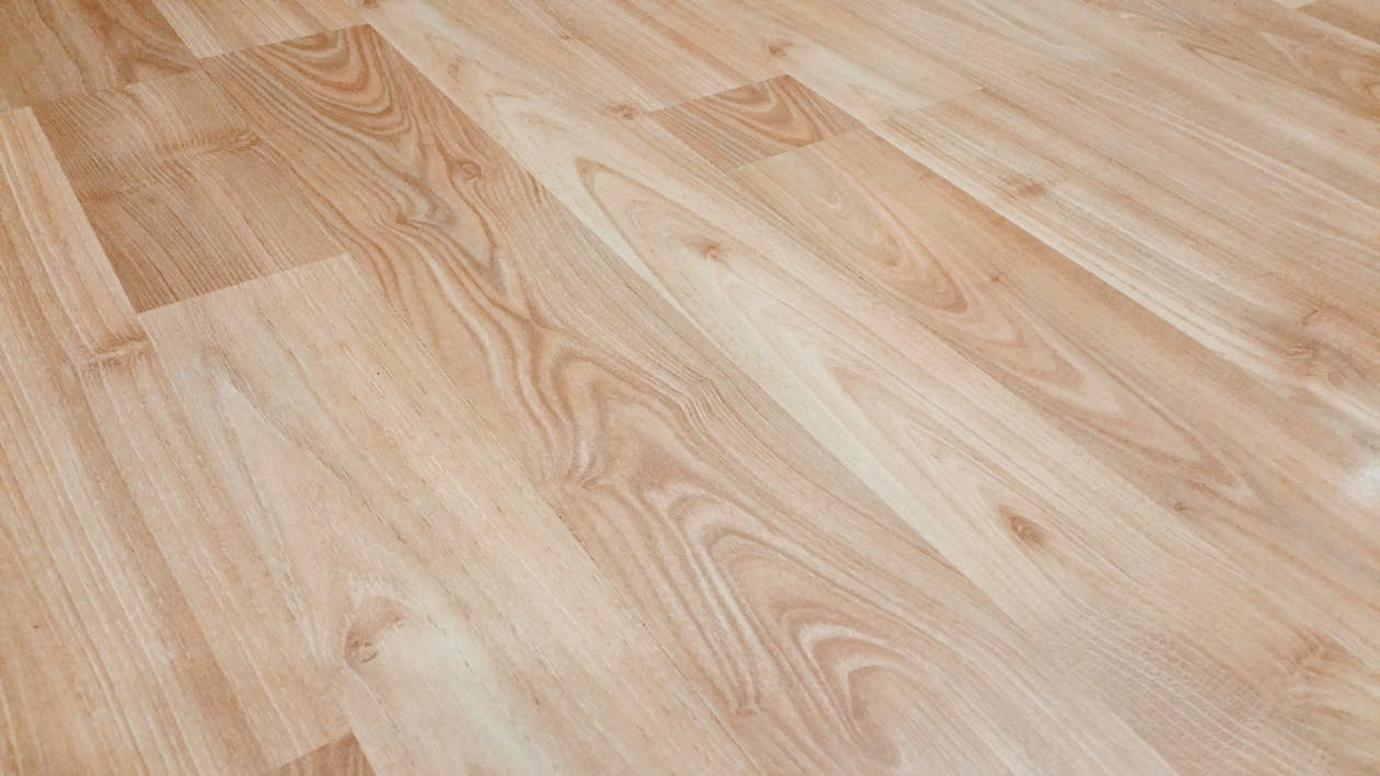 Light-colored, wood-look flooring in a basement.